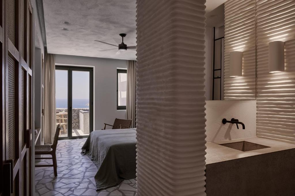 Tempat tidur dalam kamar di Archipelagos All Suites