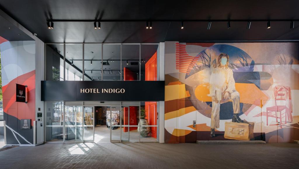 a lobby of a hotel indoco with a mural on the wall at Hotel Indigo Brisbane City Centre, an IHG Hotel in Brisbane