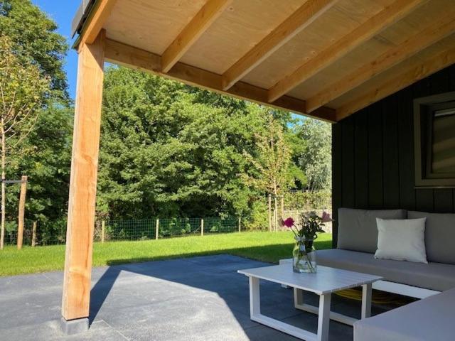 a patio with a couch and a table under a pavilion at Hip in Sint Maarten by Droomvilla in Sint Maarten