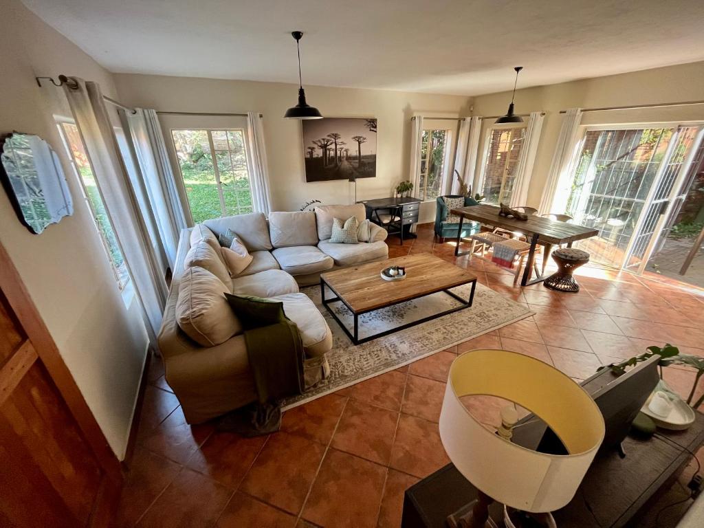 a living room with a couch and a table at Spacious 2-bed, 2-bath villa with garden and parking in Mataffin