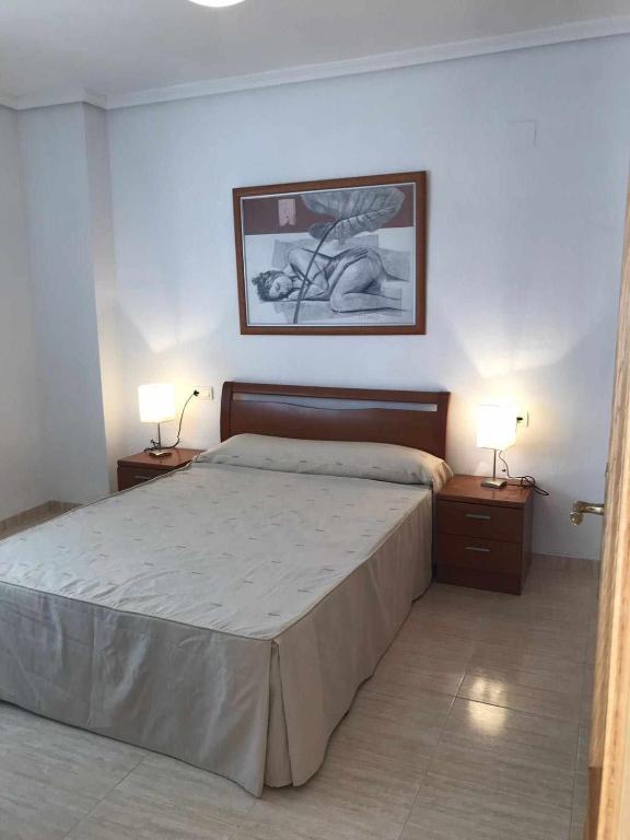 A bed or beds in a room at Apartamento a primera linea de playa ideal para relajarte - COSTA MARINA III