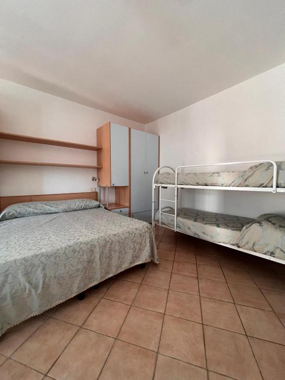 A bed or beds in a room at Appartamenti Serena