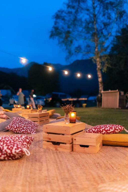 a wooden table with a candle on top of it at Hotel Bohinj in Bohinj