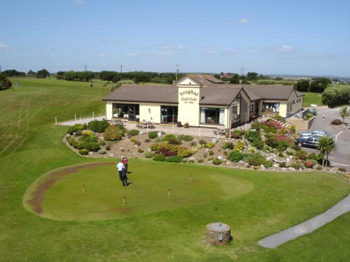 a person is playing golf on a golf course at Key Locker by WhatsApp , Joanna's Little Studio, Own entrance, Own Bathroom in Youghal