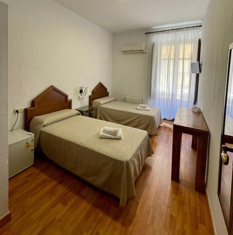 Posteľ alebo postele v izbe v ubytovaní Arteaga Hostal & Baños Arabes Elvira