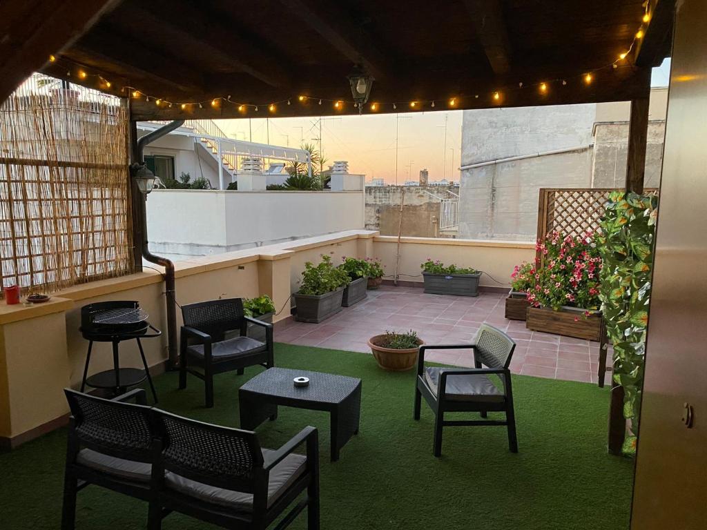 a patio with chairs and tables on a rooftop at La piccola terrazza in Bari