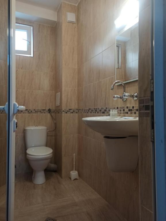 a bathroom with a toilet and a sink at Family Hotel Silitur in Ahtopol