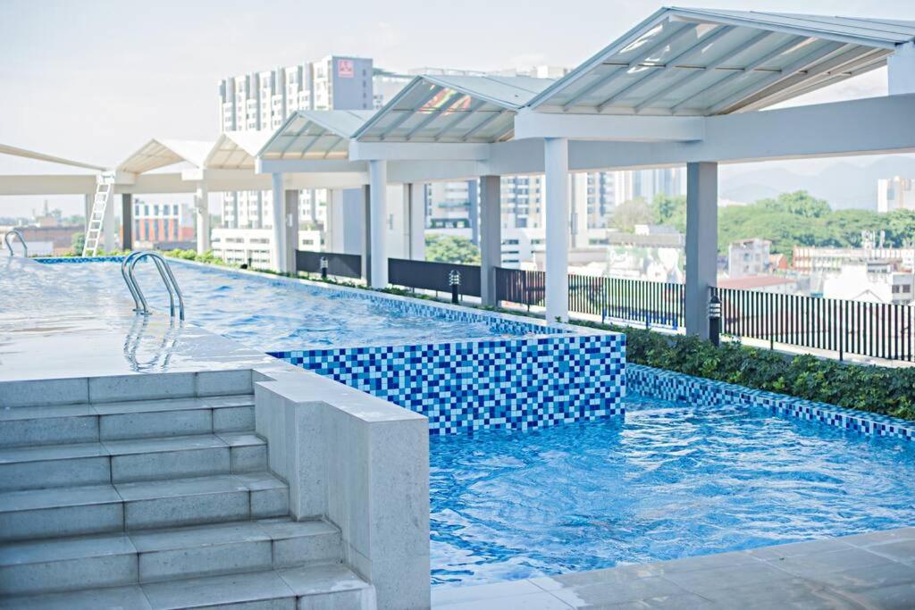 a swimming pool on top of a building at Octagon Premium Ipoh Town Center 2BR 101 by Grab A Stay in Ipoh