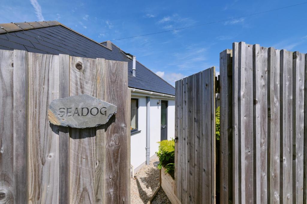 a wooden fence with a sign on it at Finest Retreats - Seadog in Porthleven