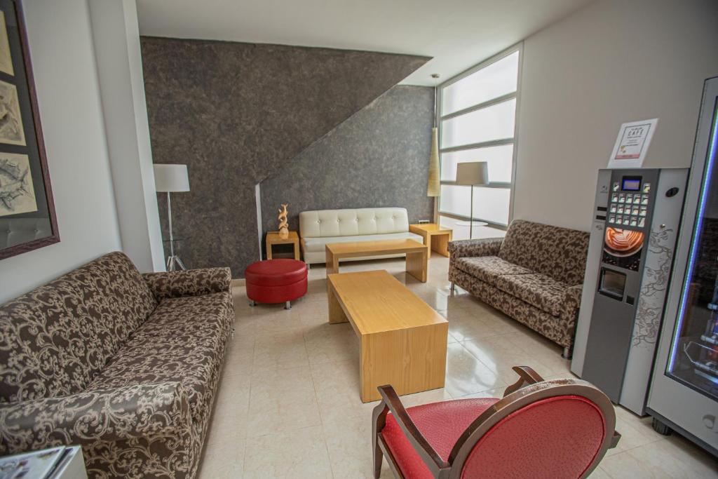 a living room with couches and a coffee table at Hotel Adiafa in Barbate