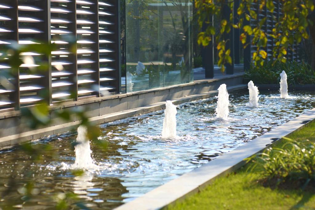 a row of water fountains in a park at Belgravia Serviced Residence Wuxi in Wuxi
