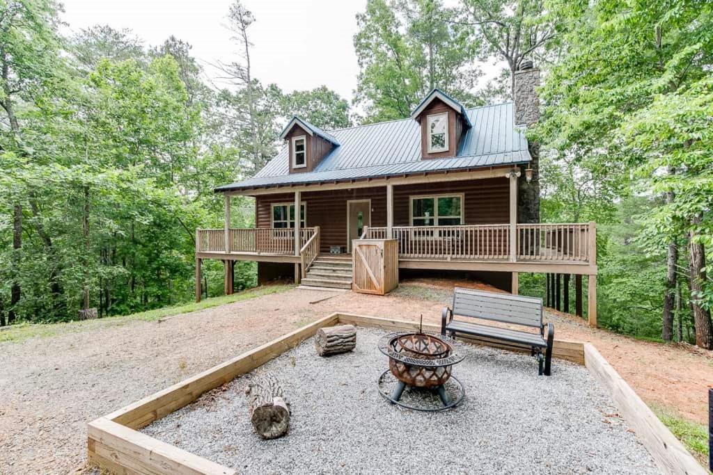 a log cabin with a bench in front of it at Listen to Chattahoochee RiverSleeps 8Near Helen in Sautee Nacoochee