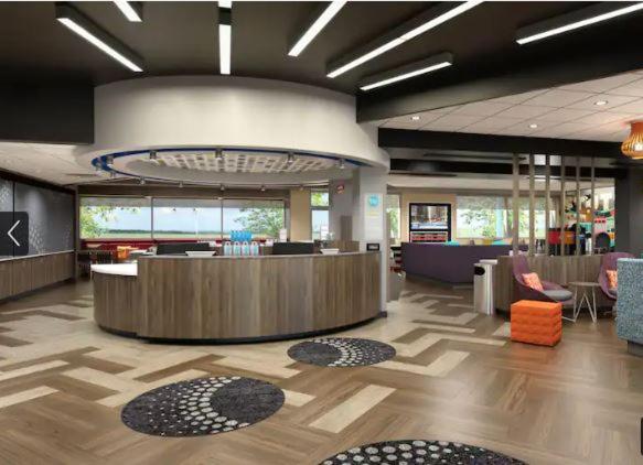 a lobby with a waiting area with chairs and a desk at Tru By Hilton Indianapolis Lawrence, In in Indianapolis