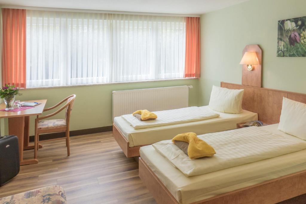 Letto o letti in una camera di Hotel Thüringenschanze