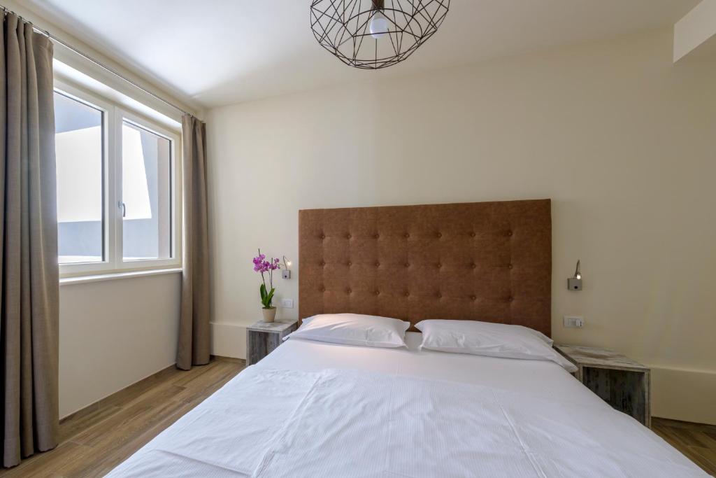 Postel nebo postele na pokoji v ubytování Residence Ruculì - Ruculì Hospitality