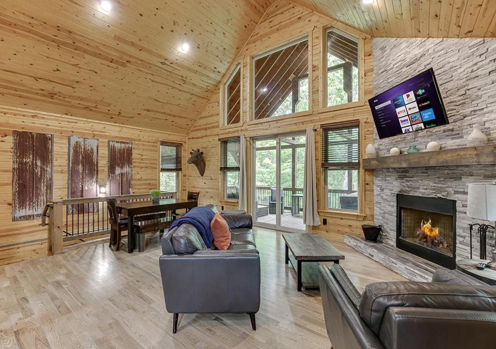 a living room with a couch and a fireplace at Cabin Near Helen, GA w Spa Amenities in Cornelia