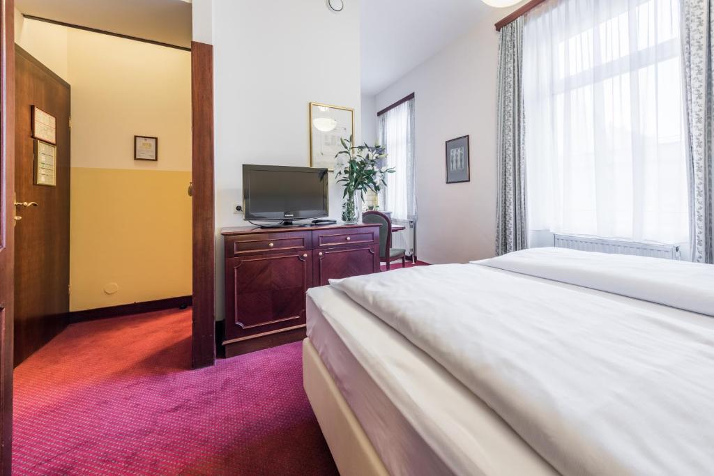 Postel nebo postele na pokoji v ubytování Theaterhotel & Suites Wien