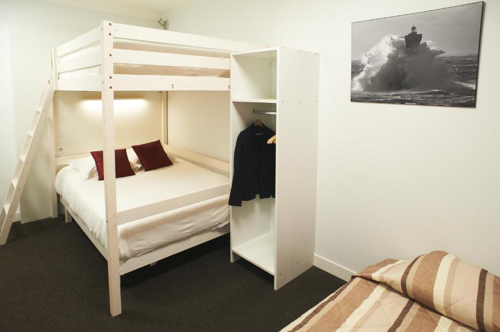 a small bedroom with a bunk bed and a bunk bed at Logis Hotel Chateaubriand in Nantes