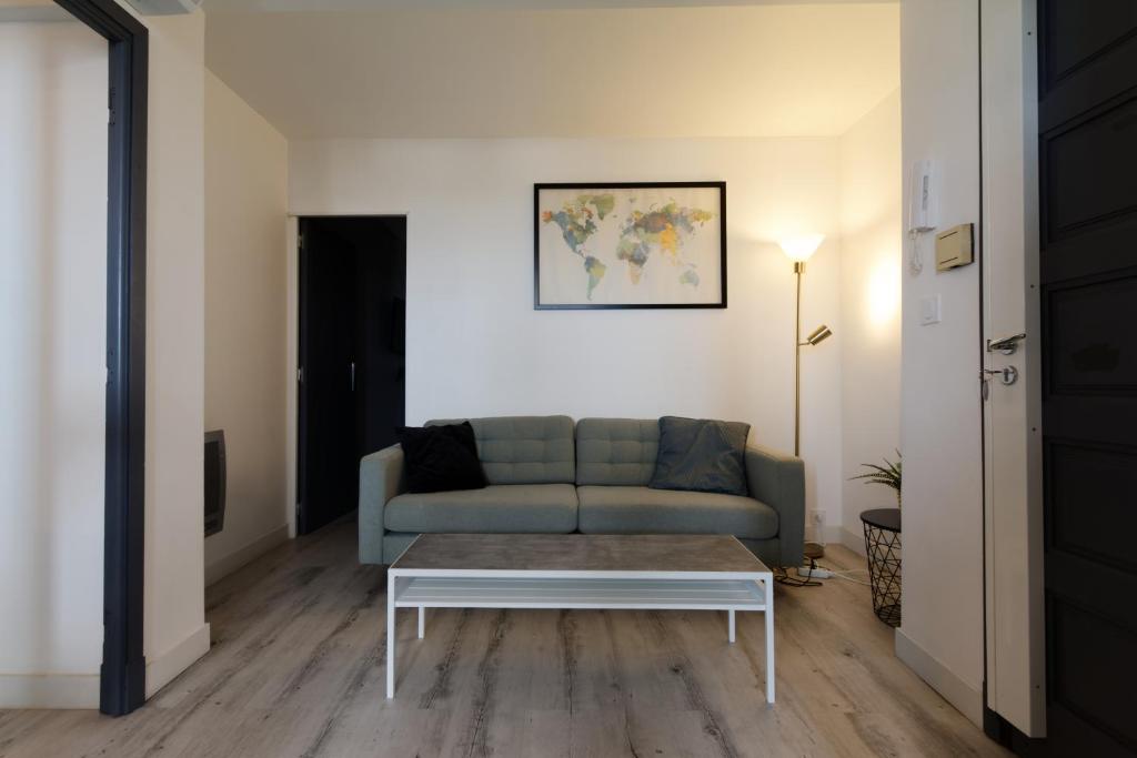 un salon avec un canapé et une table basse dans l'établissement LE BEAULIEU * Appartement 4 chambres * 8pers * Clim * Parking * Balcon, à Montpellier