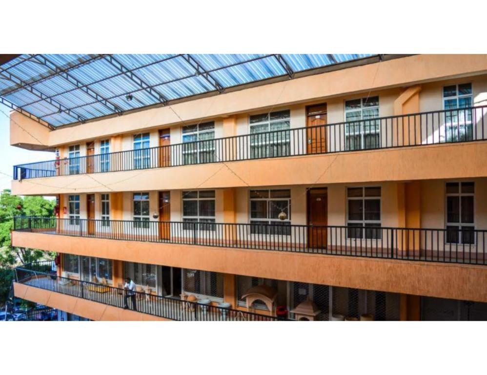 an apartment building with balconies and a glass roof at Sky Hotel Nairobi in Nairobi