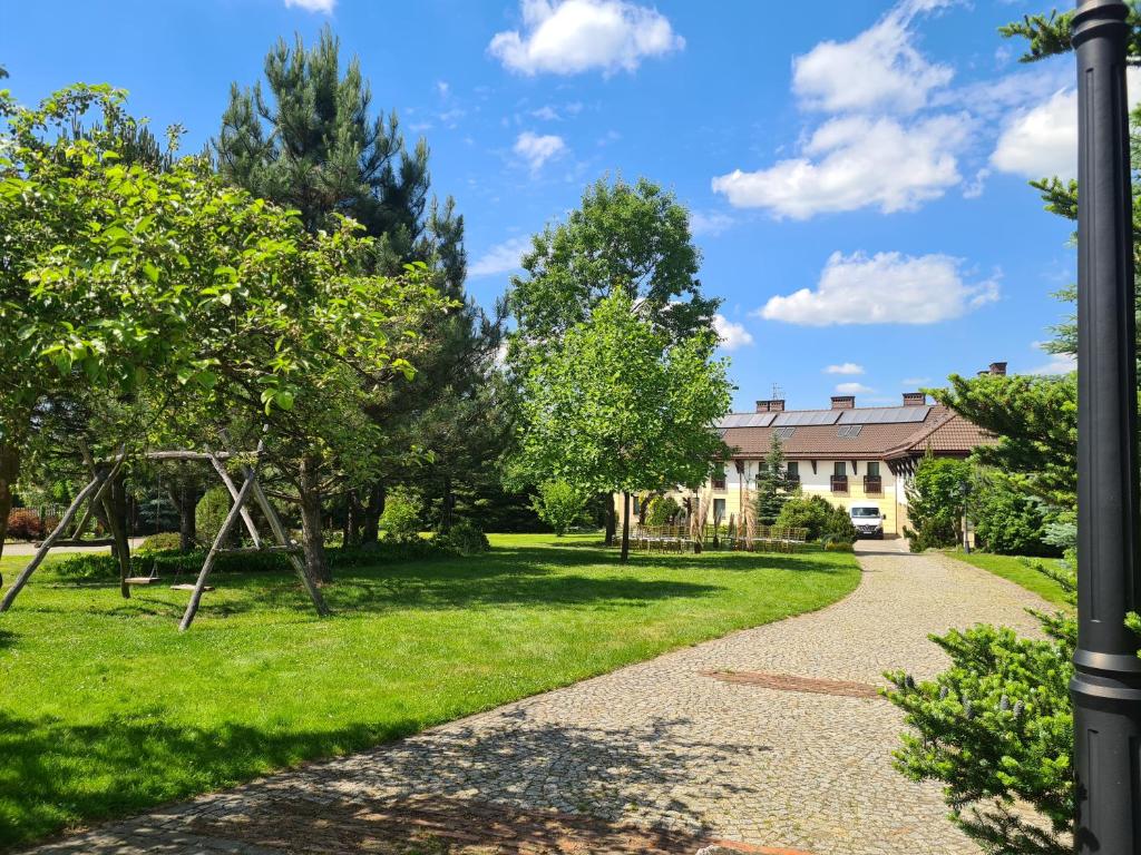 a garden with a playground and a house at Hotel & Restauracja Timberland in Orzesze