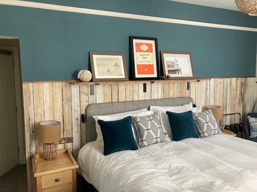 a bedroom with a bed with a blue wall at Downs Hotel in Stanmer