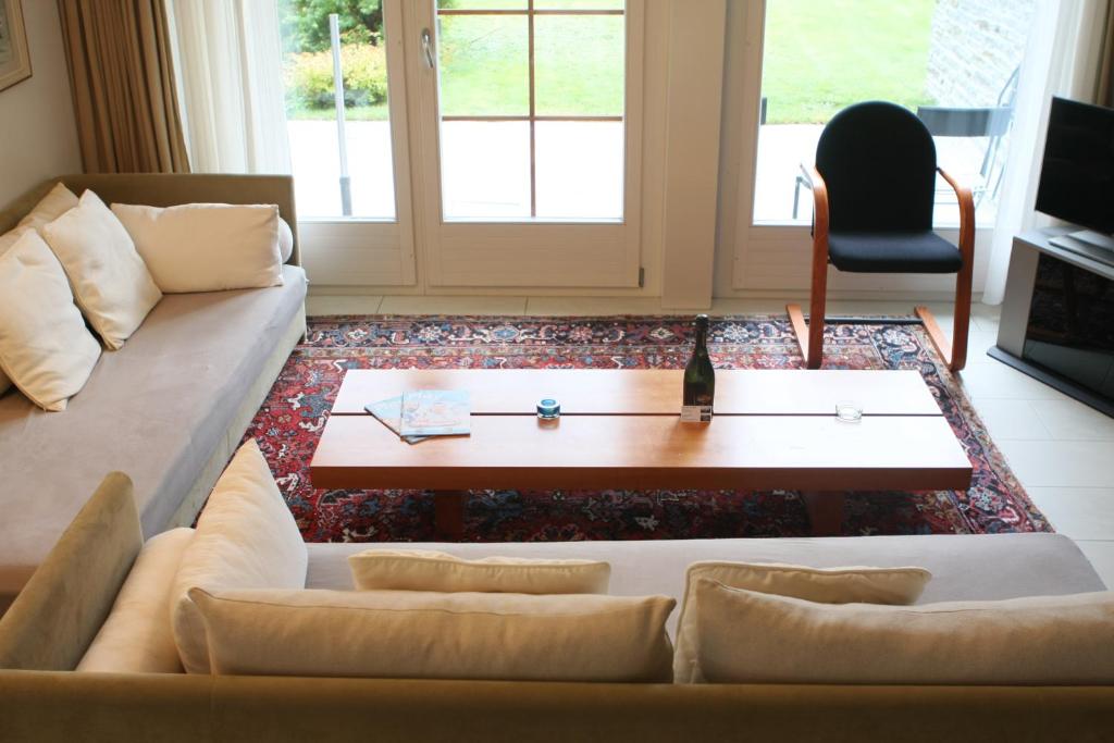 a living room with a couch and a coffee table at Zermatt La Vallée in Zermatt