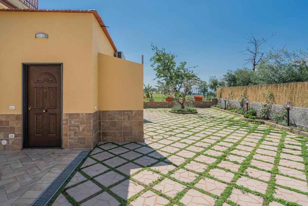 een huis met een deur en een bakstenen tuin bij Casa Vacanza Annì in Vico Equense