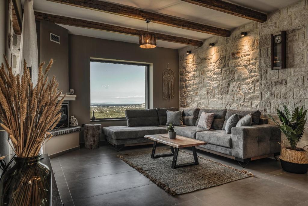 a living room with a couch and a table at Violet Private Stone Villa in Lagópodhon