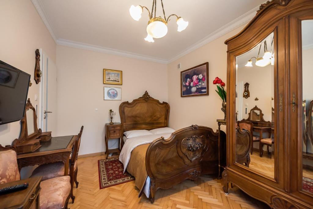 een slaapkamer met een bed en een grote spiegel bij Downtown Antique Apartment in Warschau