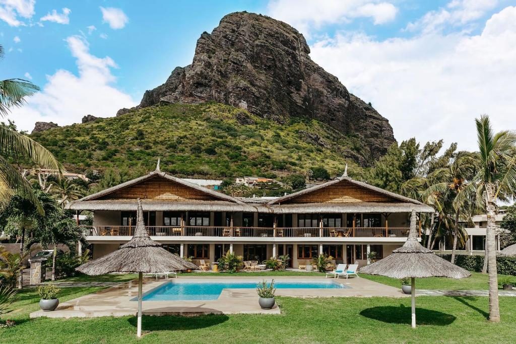 a resort with a mountain in the background at Boutik Le Morne Holiday Apartments in Le Morne