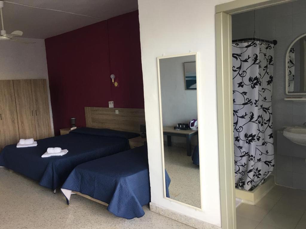 Postel nebo postele na pokoji v ubytování Roma Hotel