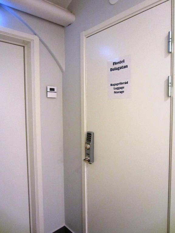 a room with a door with a sign on it at Hostel Dalagatan in Stockholm