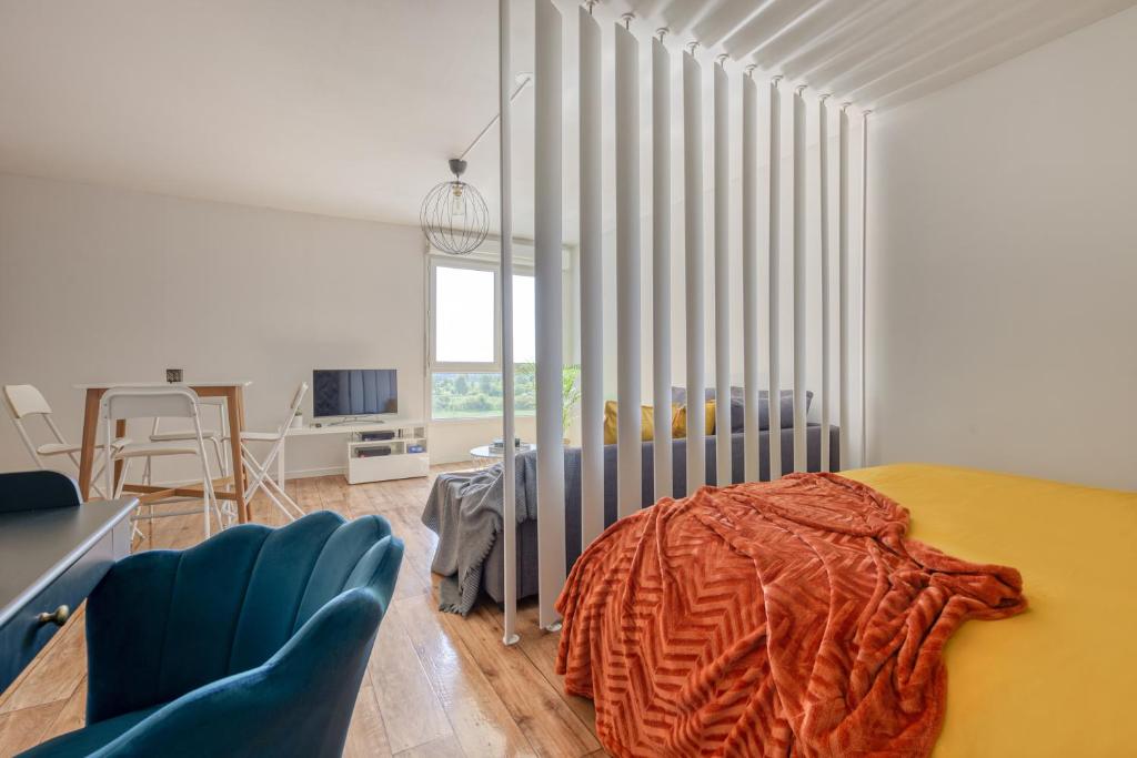 une chambre avec un lit et des chaises dans une pièce dans l'établissement Grand studio Disney, queen size, coffee, WIFI, à Montévrain