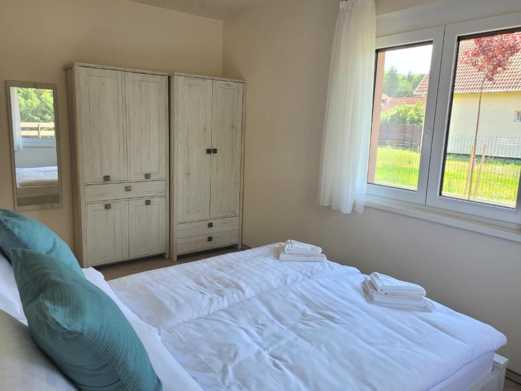 A bed or beds in a room at Silver Lodge Vendégház Egerszalók