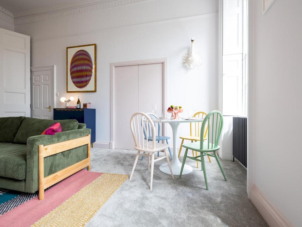 a living room with a table and chairs and a couch at Pass the Keys Stunning one bed apartment in central location in Bath