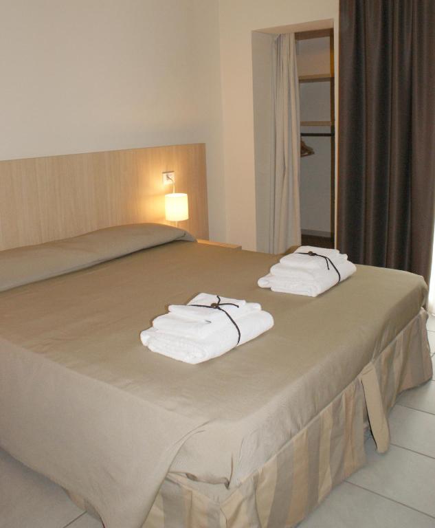 A bed or beds in a room at Residence Belmare