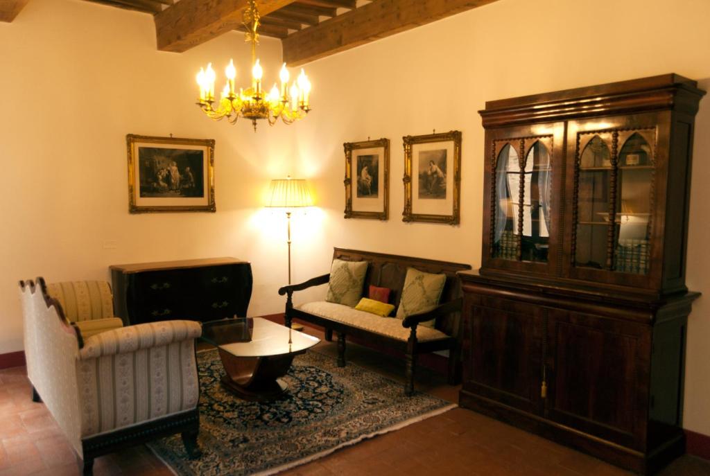 a living room with a couch and a chandelier at Palazzo Benucci in San Gimignano