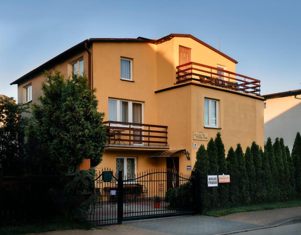 a large building with a fence in front of it at Willa Tina in Karwia