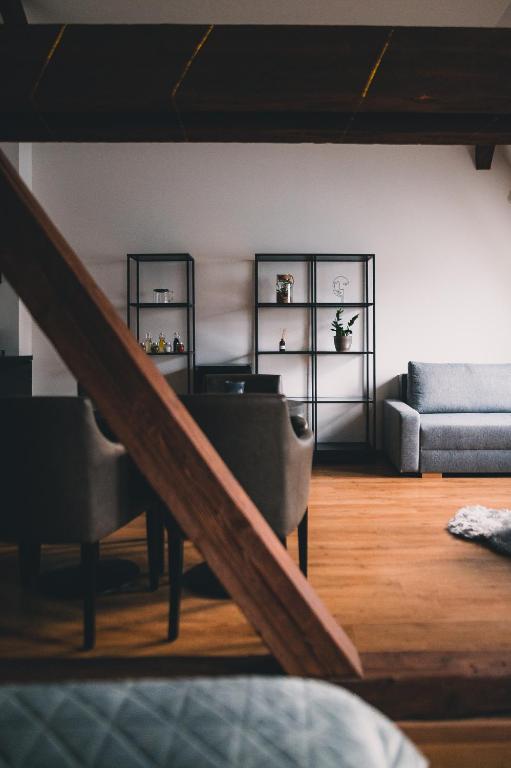 a living room with a staircase and a couch at ATRIO Apartments 2 in Trenčín