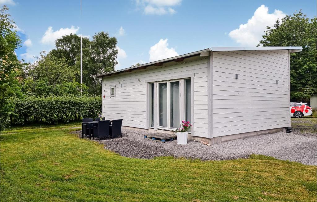 a small white shed on a gravel yard at Pet Friendly Home In Ytterby With Kitchen in Ytterby