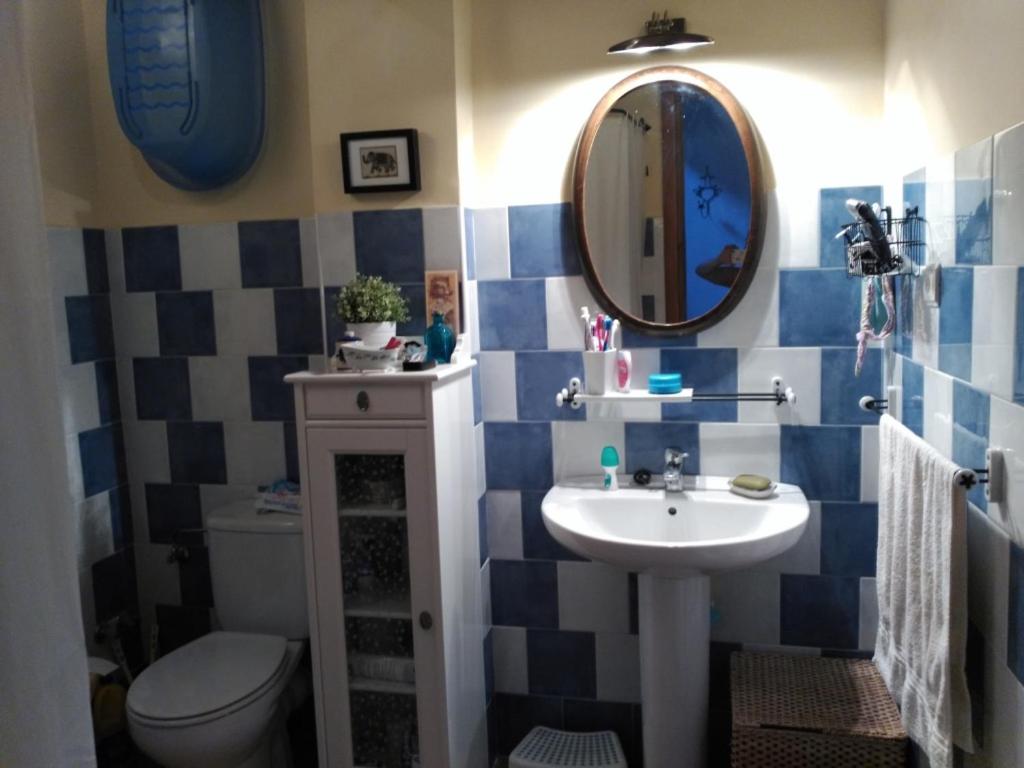 ein Badezimmer mit einem Waschbecken, einem WC und einem Spiegel in der Unterkunft Casa Rural la Escalera in Letur