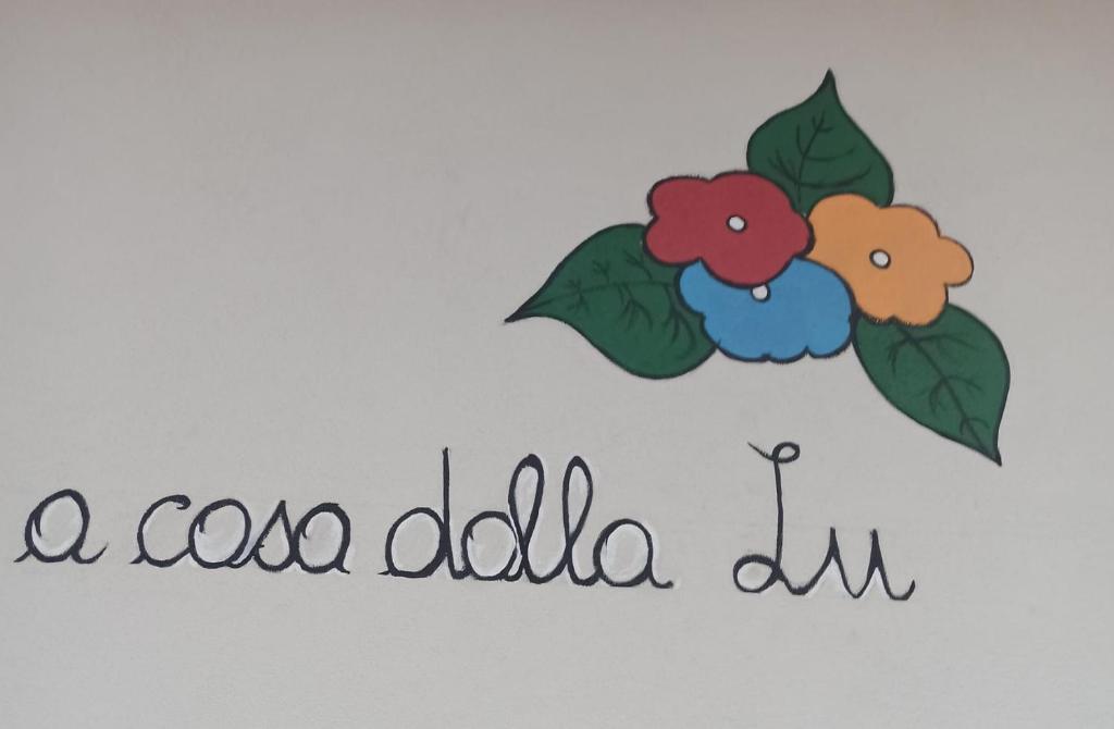 a sign that says a cooida album with flowers at A casa dalla Lu in Chiavari