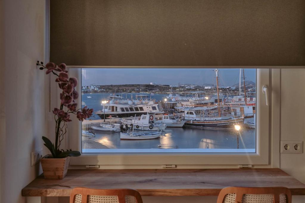 a window with a view of a marina at Nautica Suites - Modern Seaview Suite in Antiparos