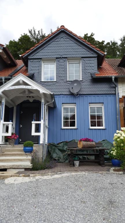 a blue house with a table in front of it at Ferienhaus "Zum Blauen Hause" in Wernigerode