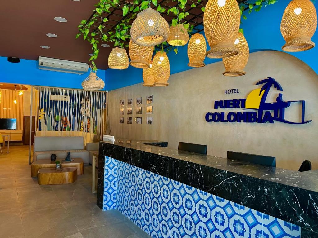 a hotel lobby with a new colombian sign and lights at Ayenda Puerto Colombia in Puerto Colombia