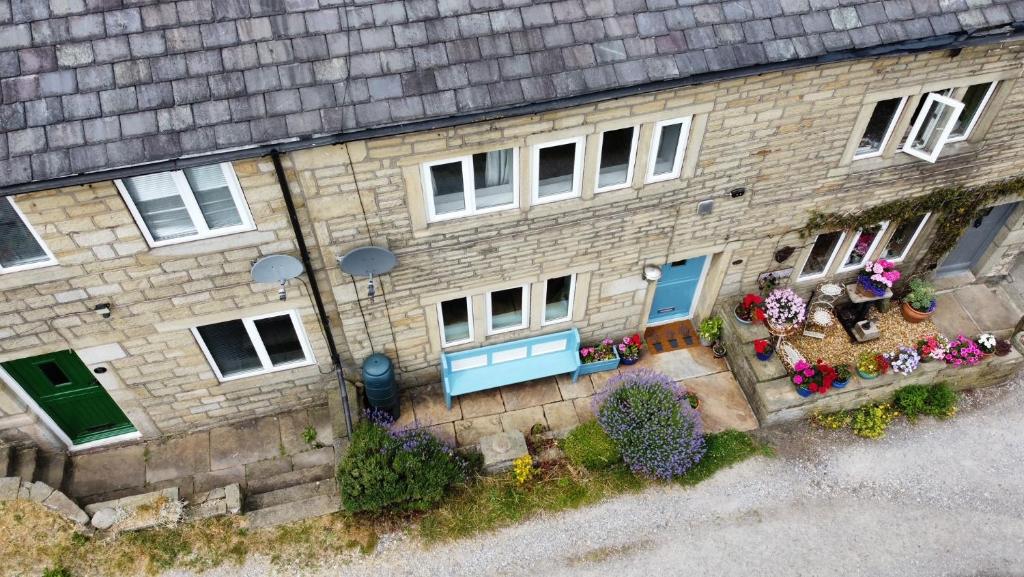 an aerial view of a house with flowers in front of it at Lavender Cottage - 18th Century Characterful Space 