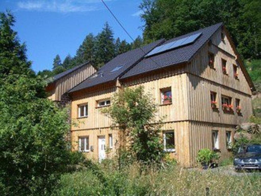 a large house with a solar roof on top of it at Ferienhaus Route 5 in Elmstein