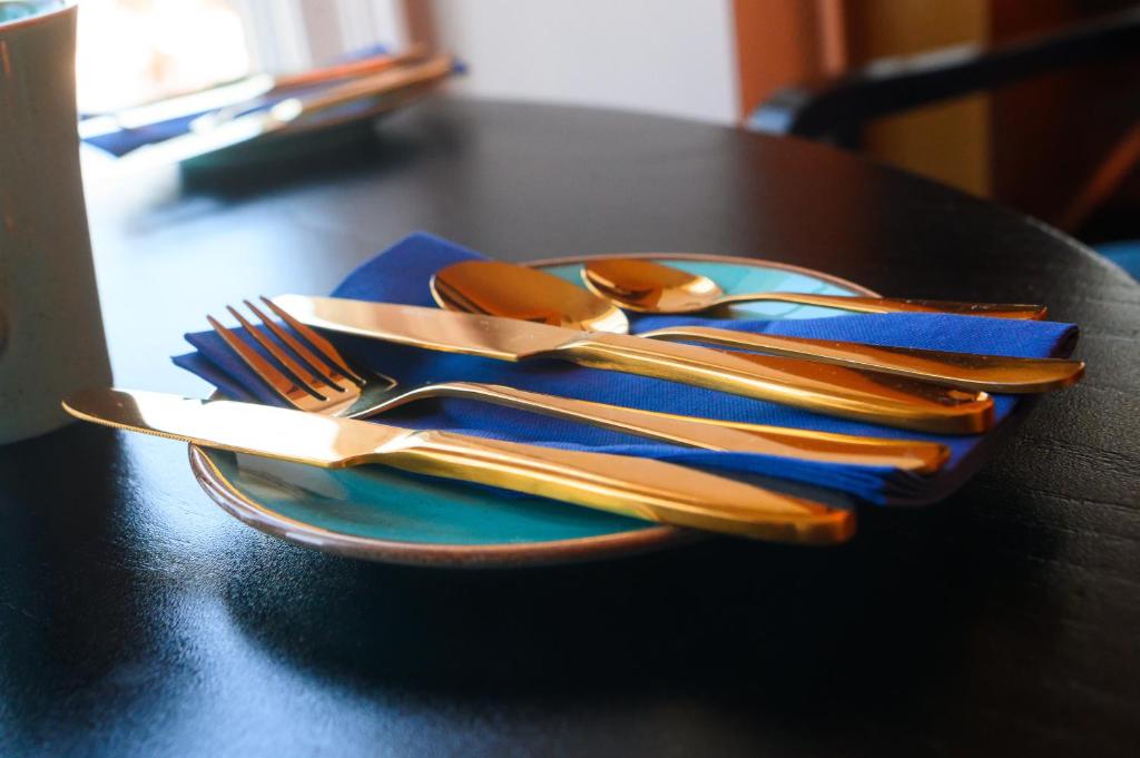 a plate with utensils on top of a table at Llandudno Bay Hotel in Llandudno