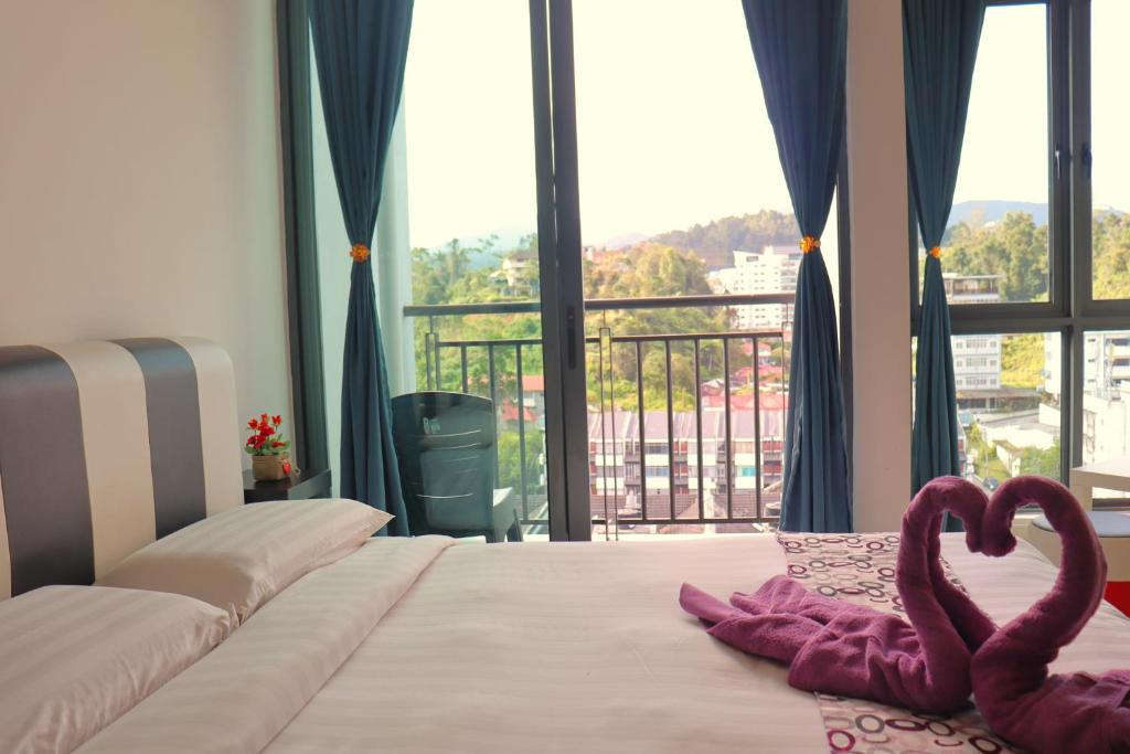Postel nebo postele na pokoji v ubytování ATS Cameron Hotel & Apartments